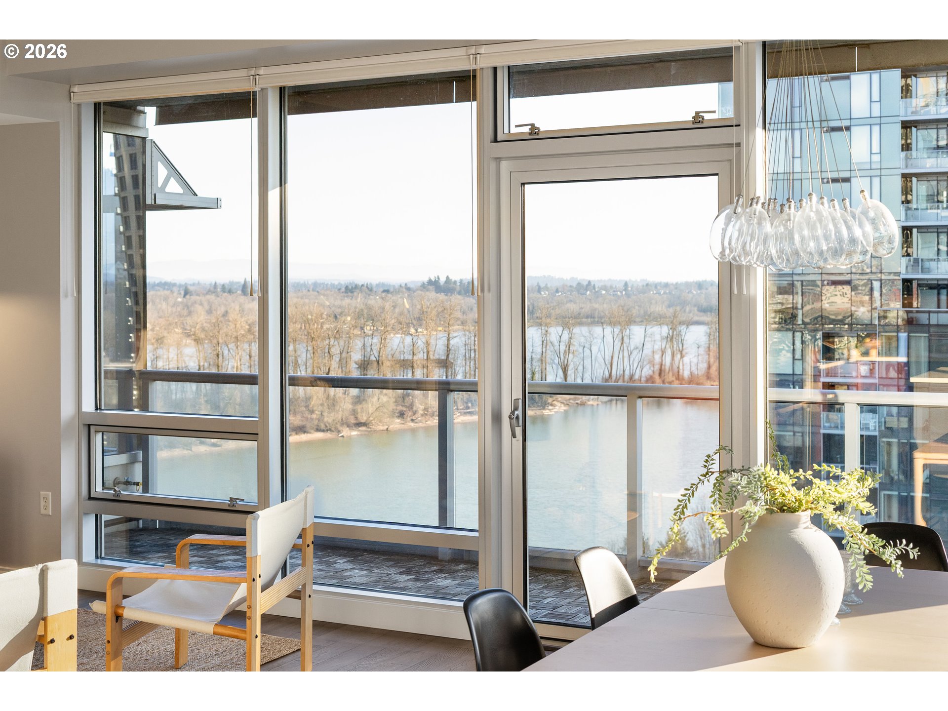 836 South Curry Street, Unit 1304 Portland, OR 97239 - Photo 4 of 34 a living room with couches and a large window with outer view