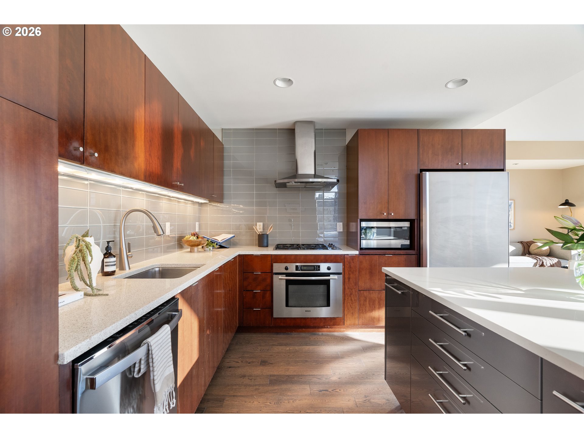 836 South Curry Street, Unit 1304 Portland, OR 97239 - Photo 10 of 34 a kitchen with kitchen island granite countertop a sink stove and refrigerator