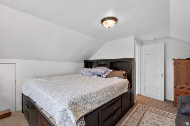 49 South 4th W Street Preston, ID 83263 - Photo 8 of 48 Bedroom featuring a textured ceiling, light carpet, and lofted ceiling