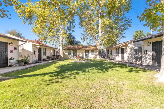 a view of a house with swimming pool and a chairs