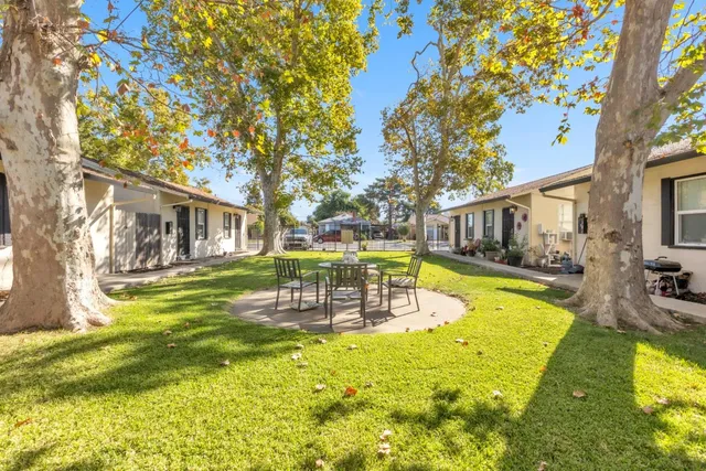 a view of a house with swimming pool and a chairs