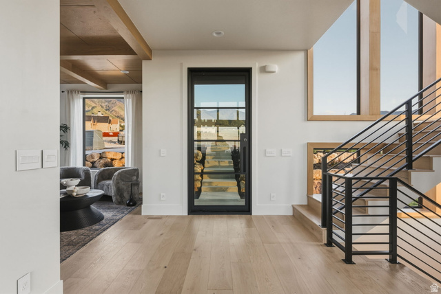 923 North Emery Lane Elk Ridge, UT 84651 - Photo 4 of 101 Entryway featuring a black-framed glass door, light wood-finish flooring, and a modern staircase with black metal railings