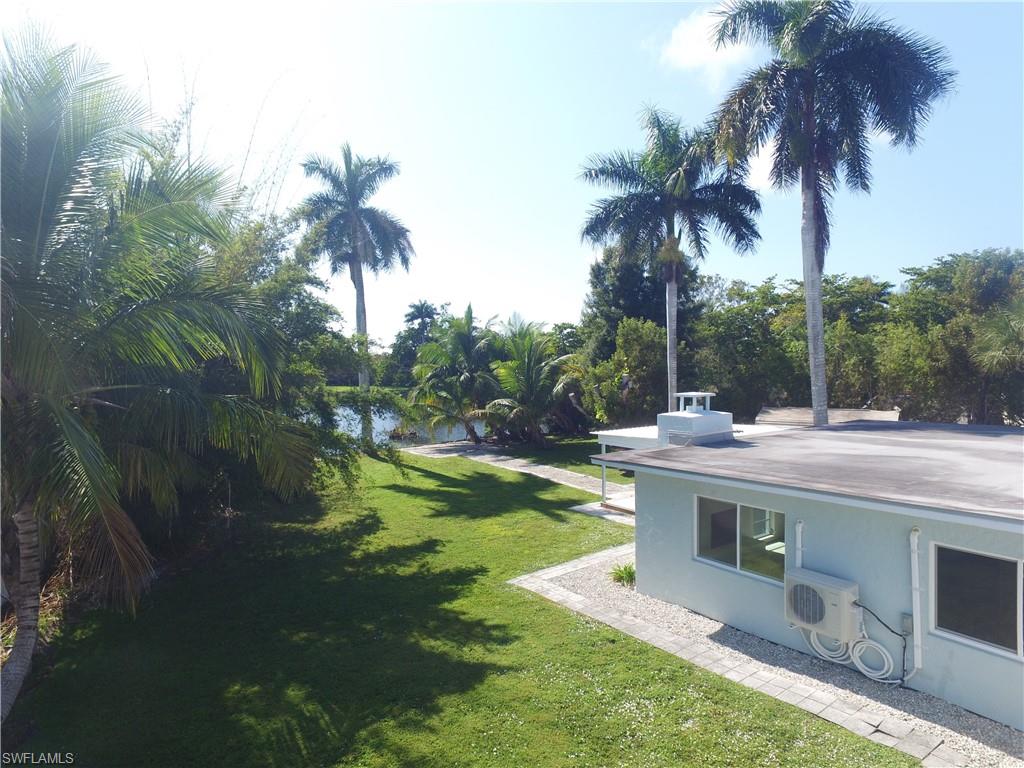 22 Constitution Drive Naples, FL 34112 - Photo 11 of 34 a view of backyard with swimming pool and outdoor seating