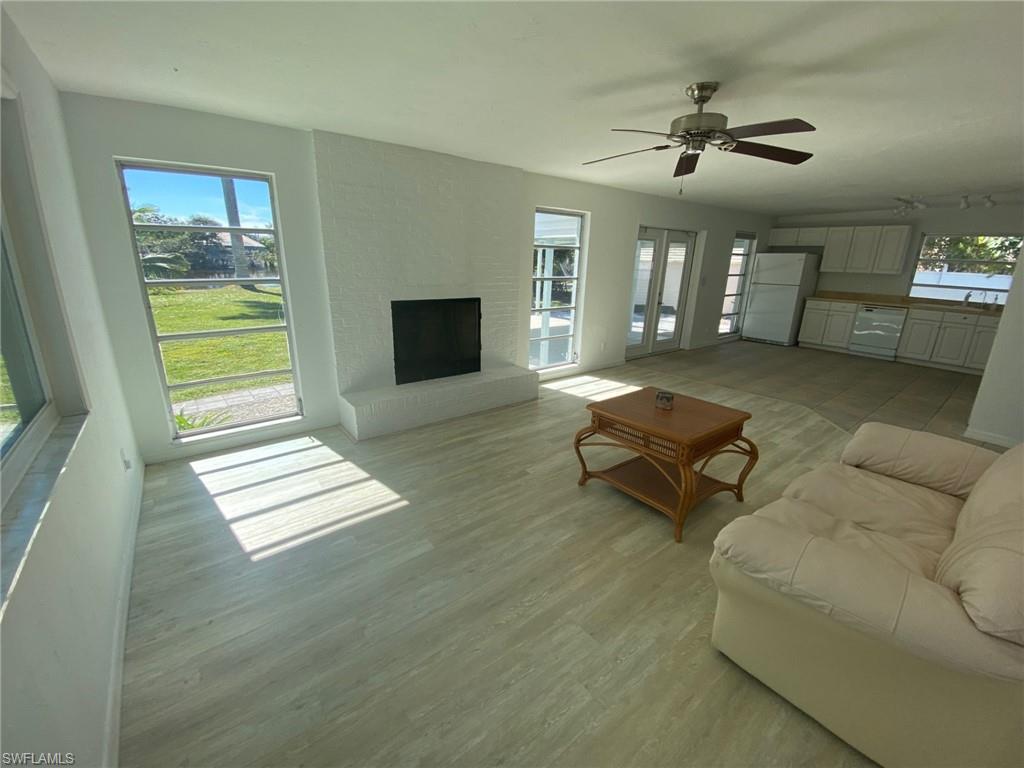 22 Constitution Drive Naples, FL 34112 - Photo 14 of 30 a living room with furniture and a fireplace