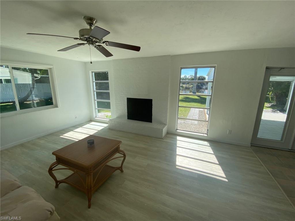 22 Constitution Drive Naples, FL 34112 - Photo 17 of 30 a living room with furniture and a fireplace