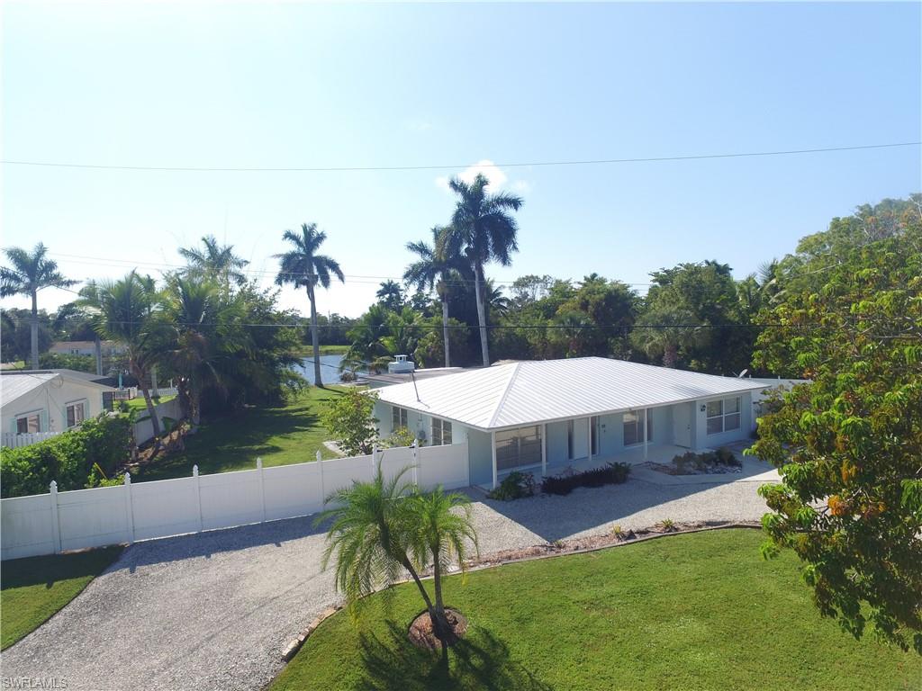 22 Constitution Drive Naples, FL 34112 - Photo 2 of 30 a view of a house with pool and a yard