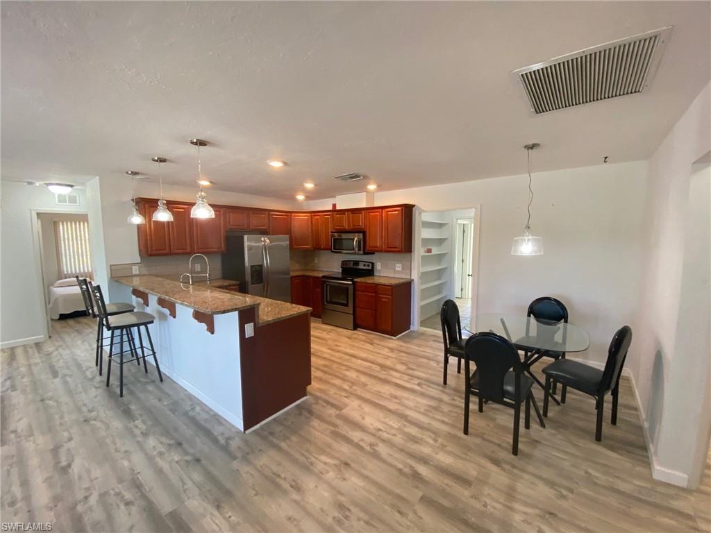 22 Constitution Drive Naples, FL 34112 - Photo 21 of 30 a kitchen with a table and chairs