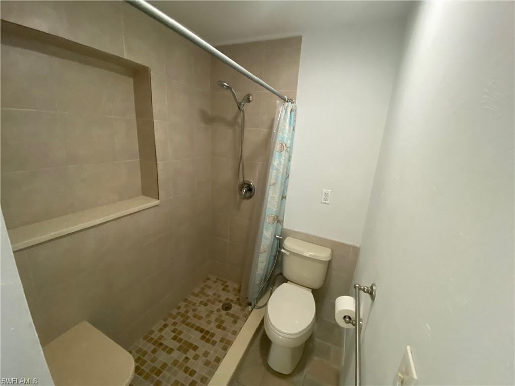 22 Constitution Drive Naples, FL 34112 - Photo 24 of 34 a white toilet sitting next to a shower