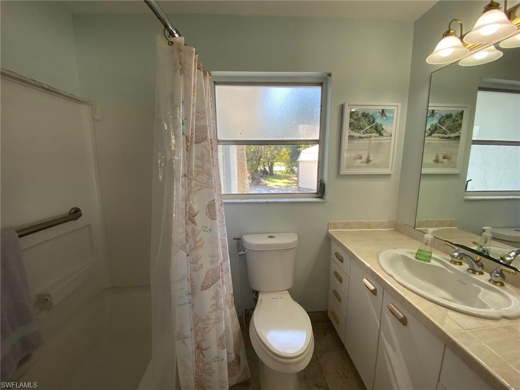 22 Constitution Drive Naples, FL 34112 - Photo 27 of 30 a bathroom with a toilet sink and mirror