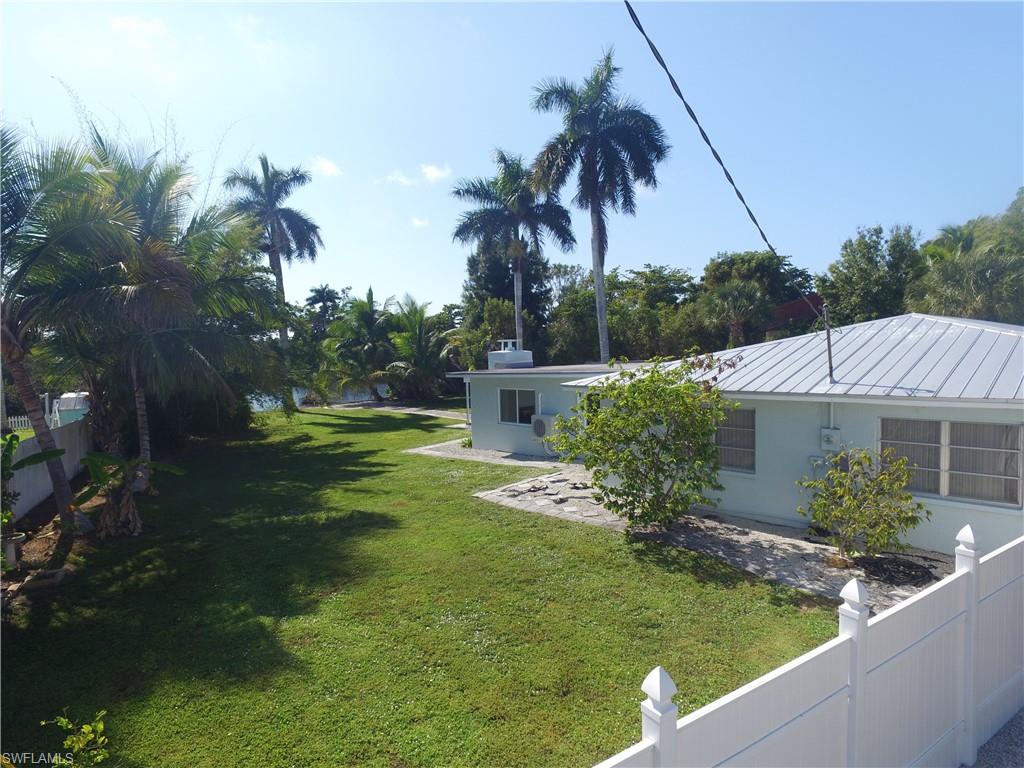 22 Constitution Drive Naples, FL 34112 - Photo 4 of 30 a view of a house with a yard and potted plants