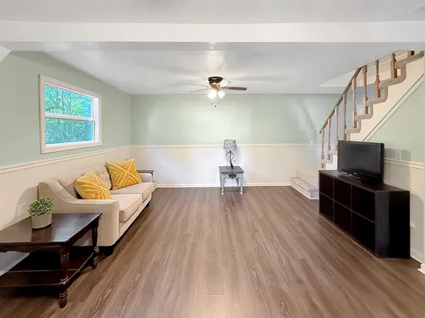 a living room with furniture and a flat screen tv