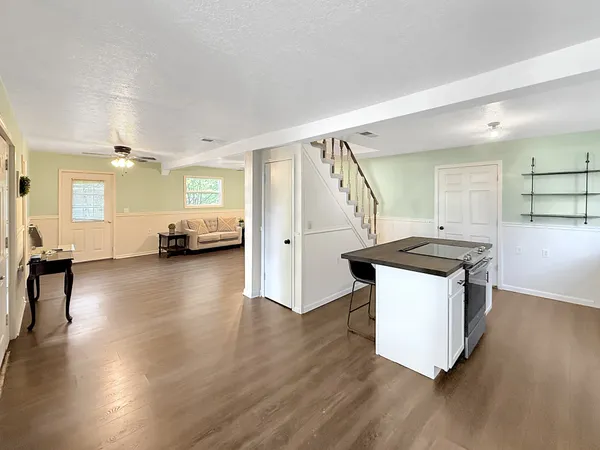 a kitchen with stainless steel appliances granite countertop a sink stove and wooden floor