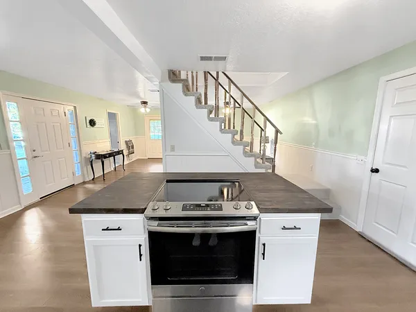 a kitchen with stainless steel appliances granite countertop a stove and a sink