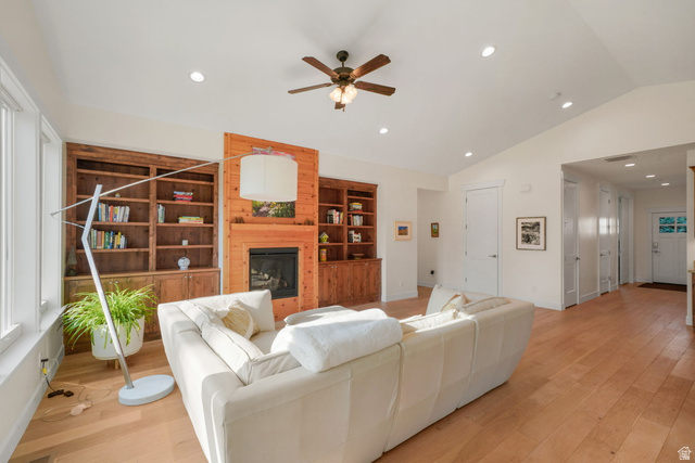 1238 Canyon View Road Midway, UT 84049 - Photo 5 of 33 Spacious living room showcasing hardwood flooring, a custom wood-frame fireplace with built-in shelving, recessed ceiling lighting, and a ceiling fan