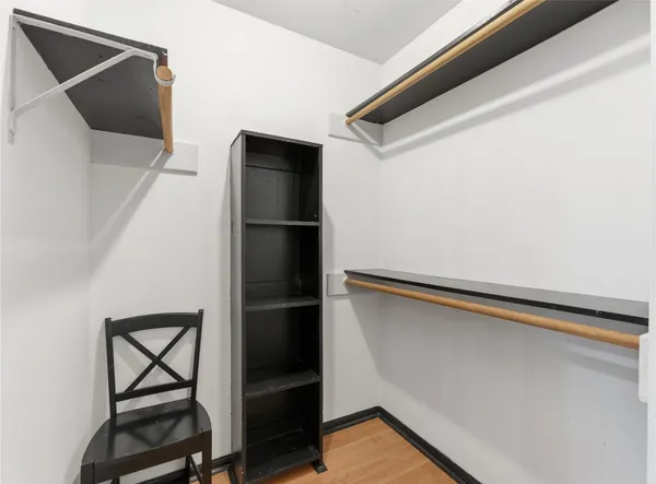 a view of walk in closet with empty racks