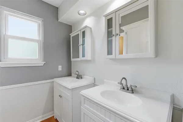 a bathroom with a granite countertop toilet and a shower