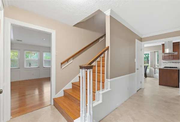 a view of staircase with railing and white walls