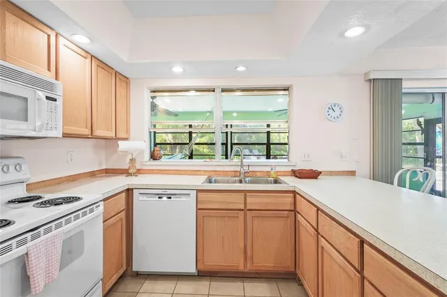 a table and chairs in a room with kitchen view