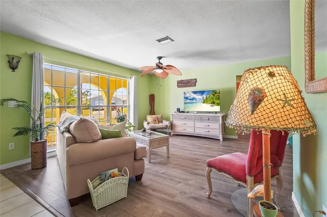 a living room with furniture and a potted plant