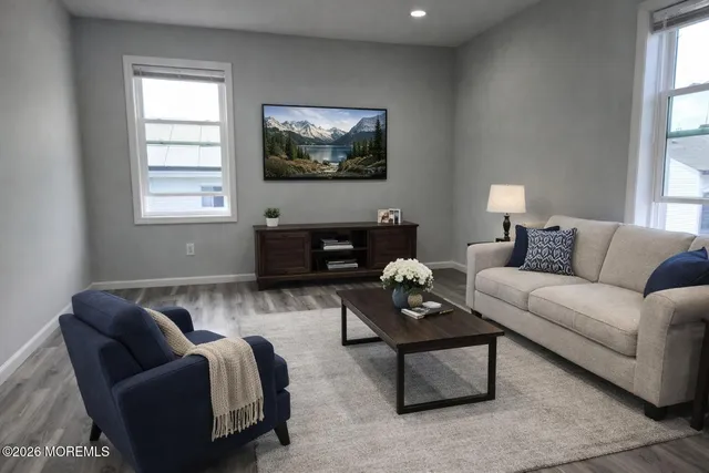 a living room with furniture a couch and a flat screen tv