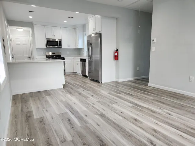 a kitchen with stainless steel appliances granite countertop a refrigerator and a stove top oven