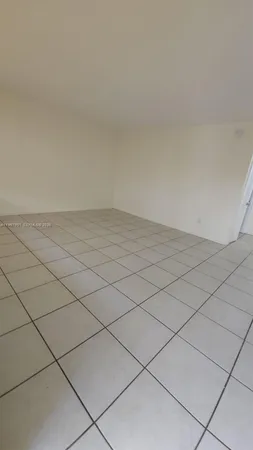 a view of kitchen and empty room