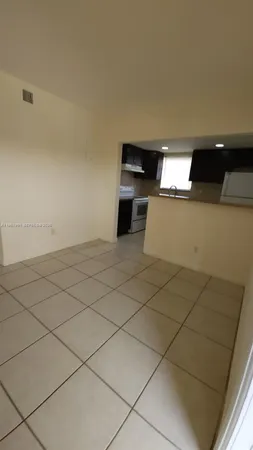 a view of a refrigerator and window in a room