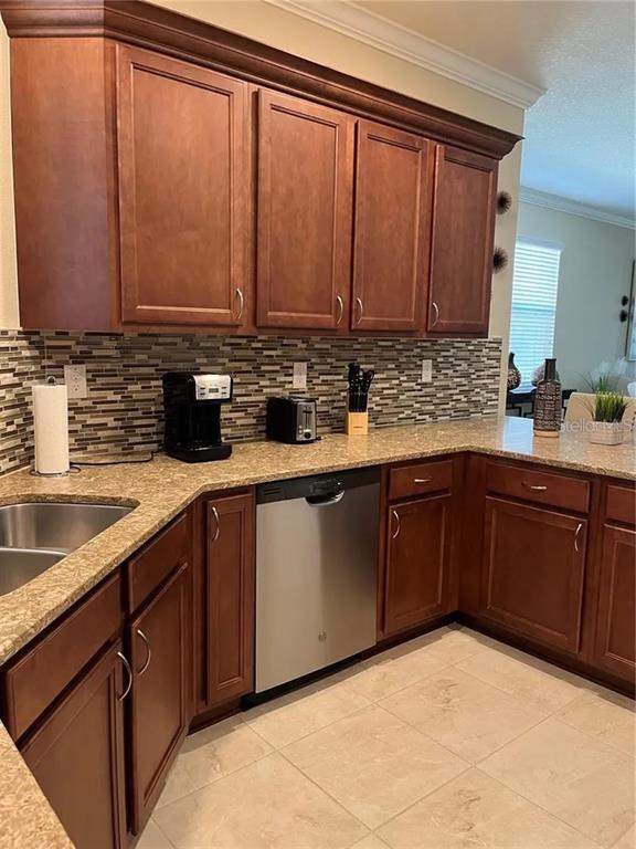 9879 Southwest 99th Loop Ocala, FL 34481 - Photo 2 of 12 a kitchen with a sink and cabinets