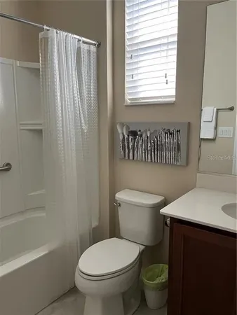 a bedroom with a bed and a lamp on table