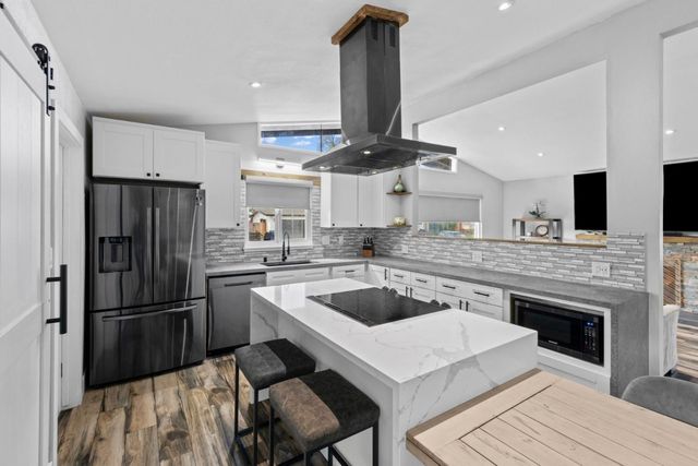a kitchen with a sink stove and cabinets