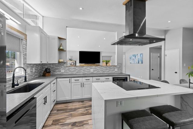 a kitchen that has a cabinets and a stove in it
