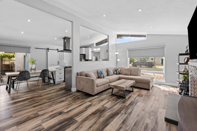 a living room with furniture a fireplace and a flat screen tv
