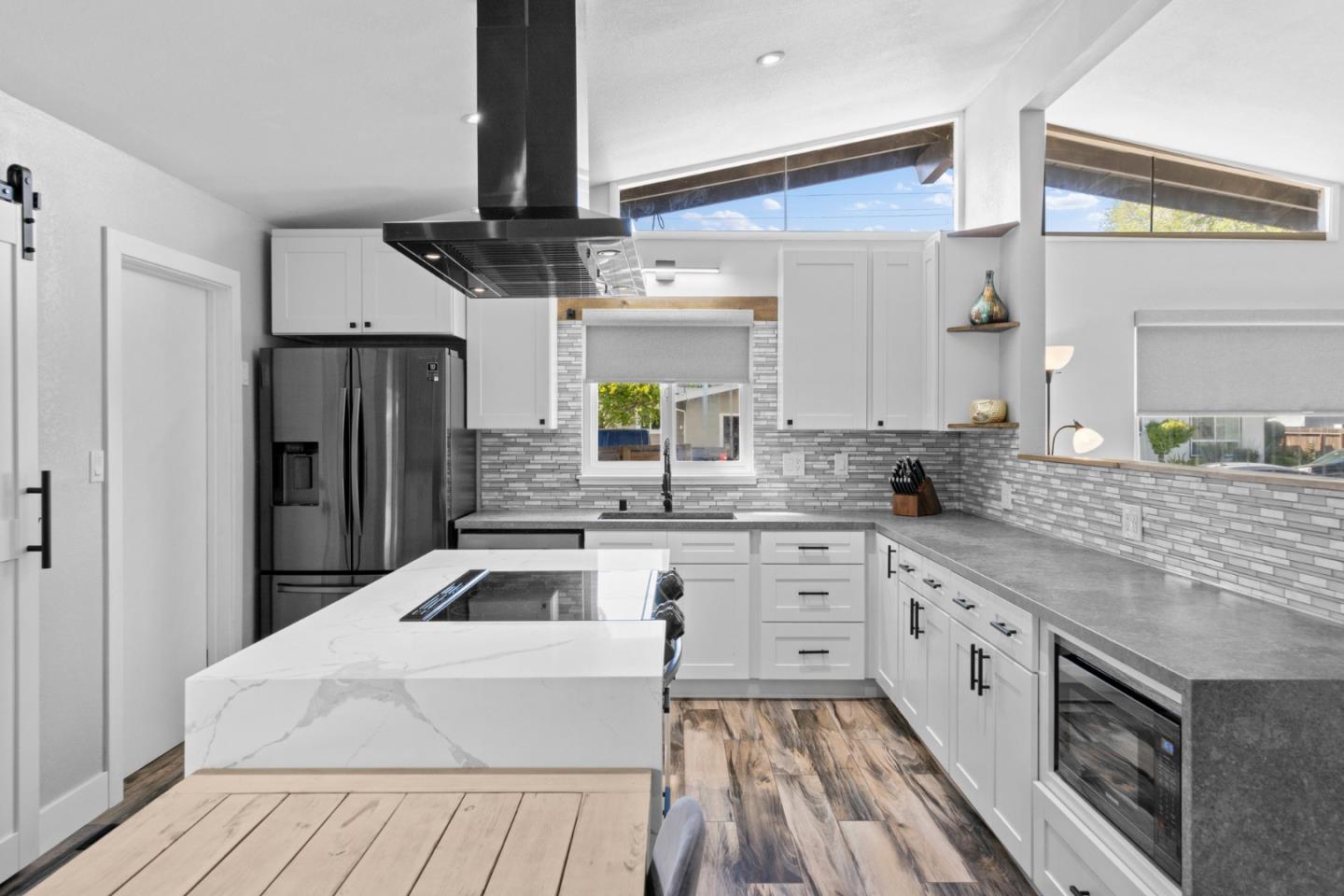 1430 Spruce Street Livermore, CA 94551 - Photo 8 of 32 a kitchen with white cabinets and stainless steel appliances