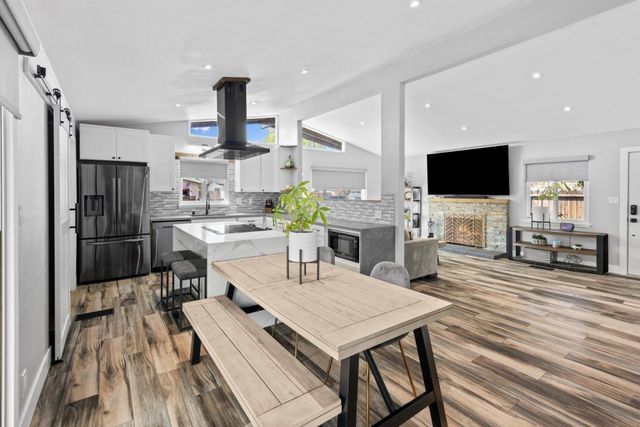 a kitchen with granite countertop a sink stainless steel appliances and cabinets