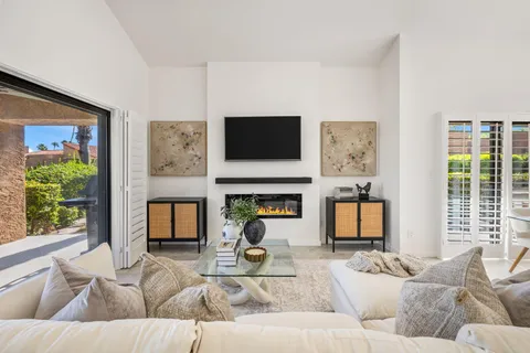 a living room with fireplace furniture and a flat screen tv