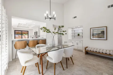 a view of a dining room with furniture and chandelier