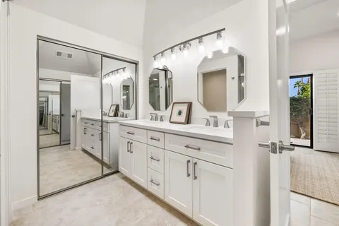 a bathroom with a double vanity sink mirror and double