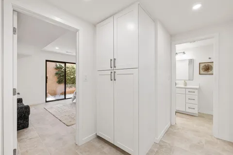 a spacious bedroom with a bed and glass window