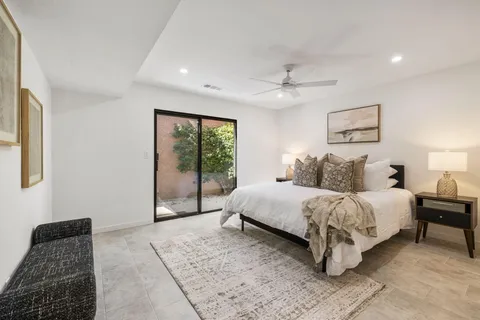 a bedroom with a large bed and a window