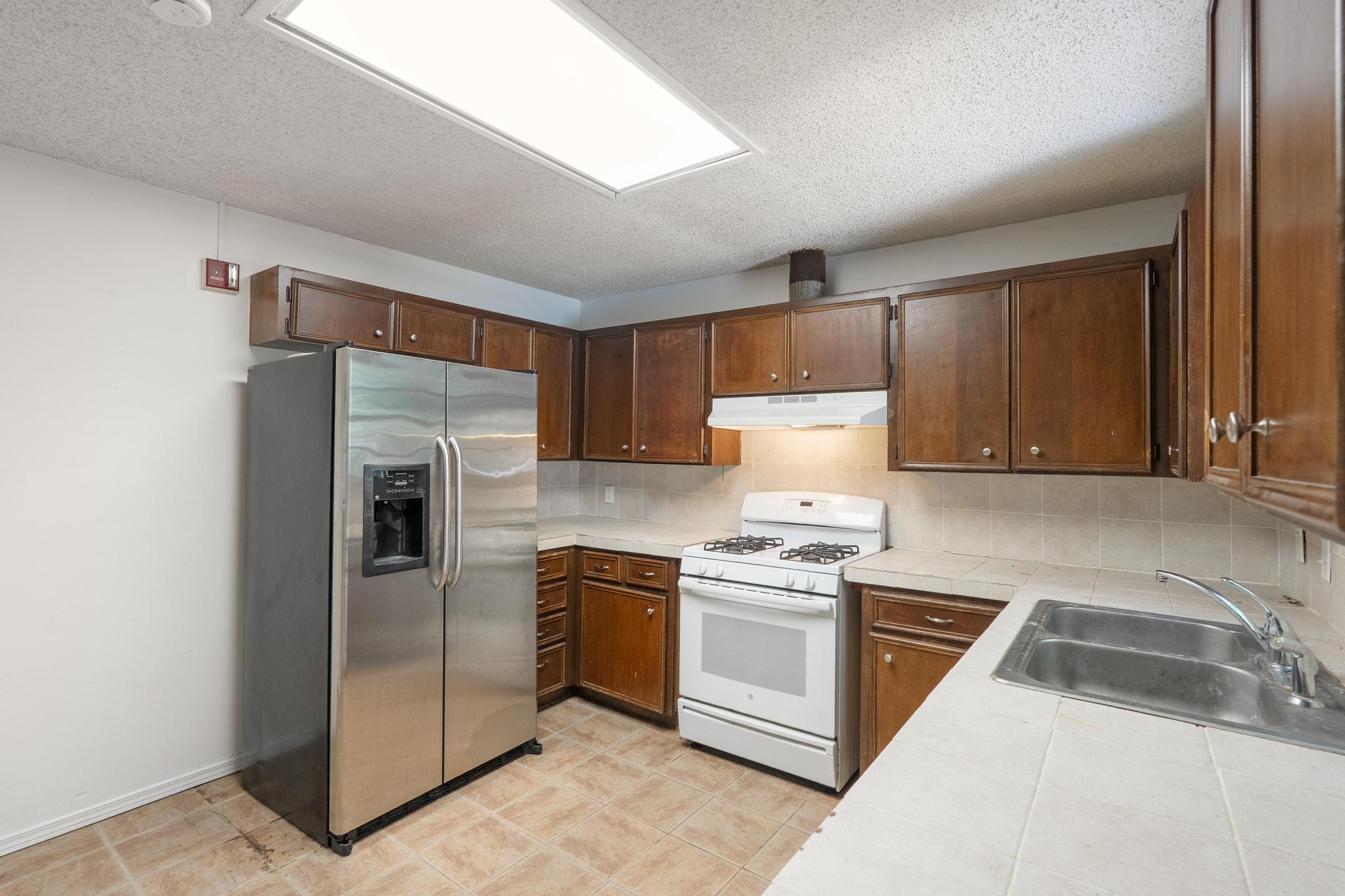 4616 East Cesar Chavez Street Austin, TX 78702 - Photo 13 of 22 a kitchen with a sink cabinets and stainless steel appliances