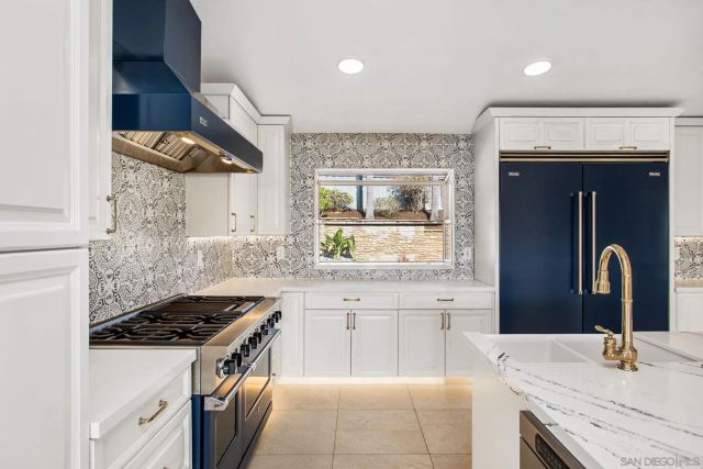 a large kitchen with a stove and a sink