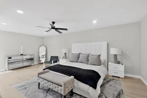 a bedroom with a bed couches and a couch