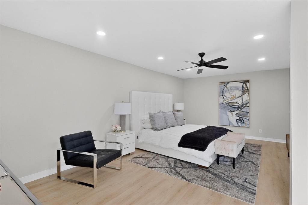 5015 Thunder Road Dallas, TX 75244 - Photo 13 of 31 a bedroom with a bed and a chandelier