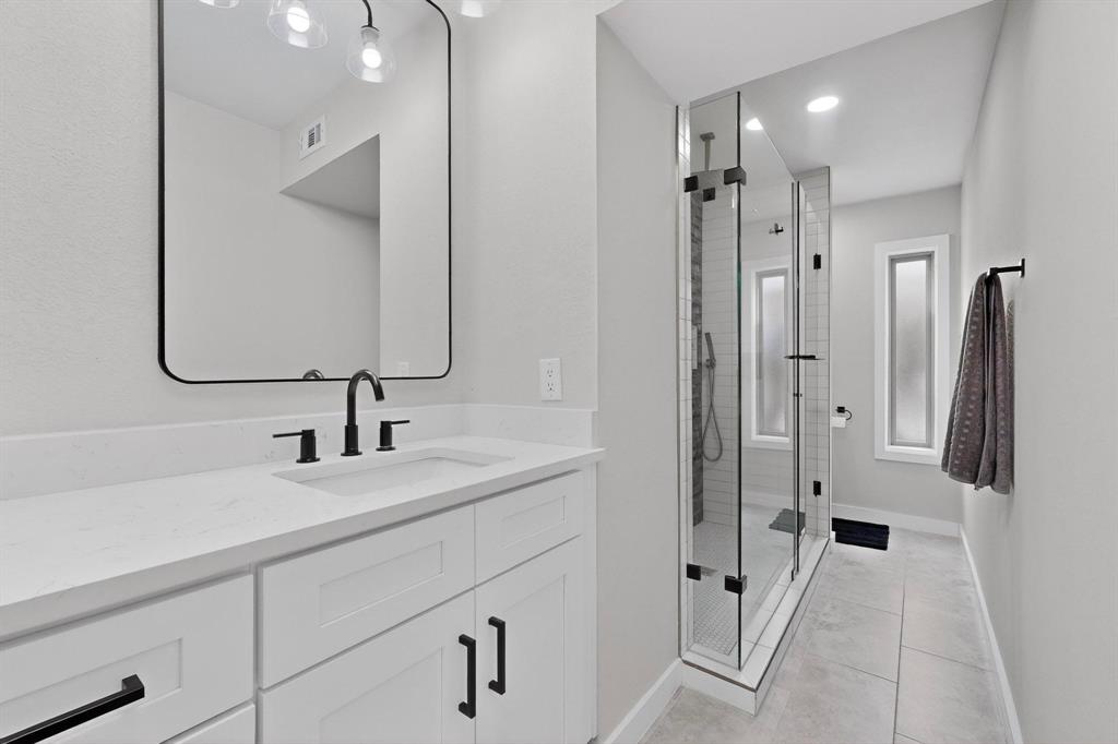 5015 Thunder Road Dallas, TX 75244 - Photo 18 of 31 a bathroom with a double vanity sink mirror and shower