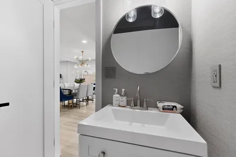 a bathroom with a sink mirror and vanity