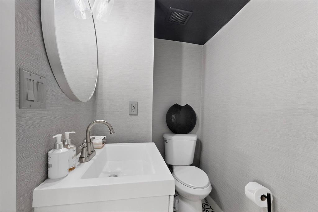 5015 Thunder Road Dallas, TX 75244 - Photo 23 of 31 a white toilet sitting next to a bathroom sink