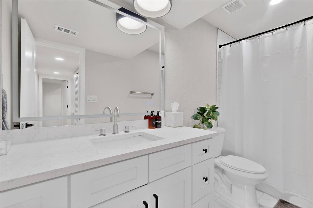 5015 Thunder Road Dallas, TX 75244 - Photo 10 of 31 a bathroom with a sink toilet and a mirror