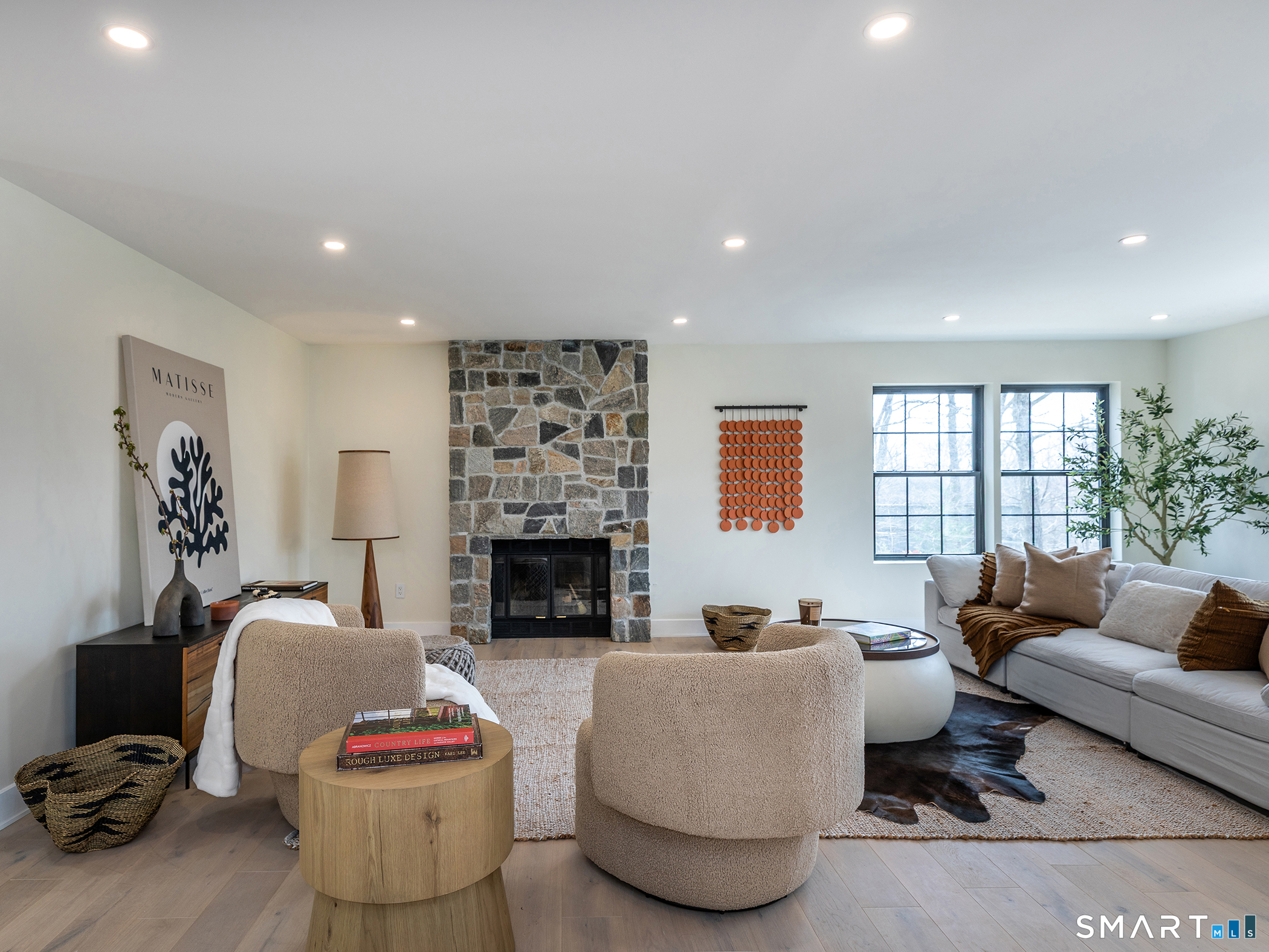 53 Mountain Lake Road Warren, CT 06777 - Photo 7 of 40 a living room with furniture and a fireplace