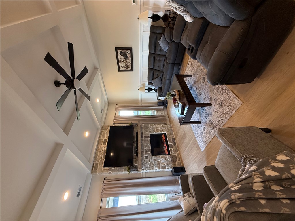 119 Dobbins Road Townville, SC 29689 - Photo 13 of 25 This inviting living space features high ceilings and a cozy fireplace, perfect for relaxation and gatherings.