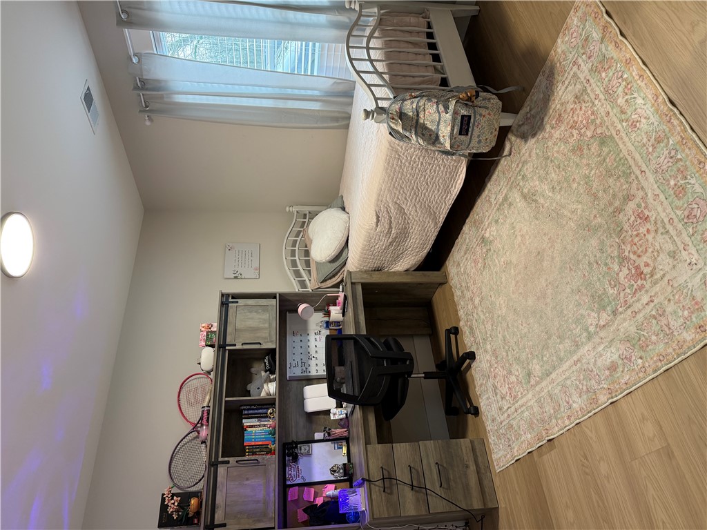 119 Dobbins Road Townville, SC 29689 - Photo 20 of 25 This cozy bedroom offers a serene retreat with elegant hardwood flooring.
